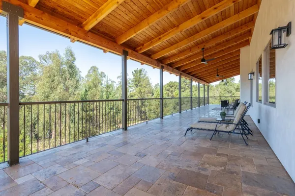 a kitchen with stainless steel appliances a dining table chairs refrigerator and window