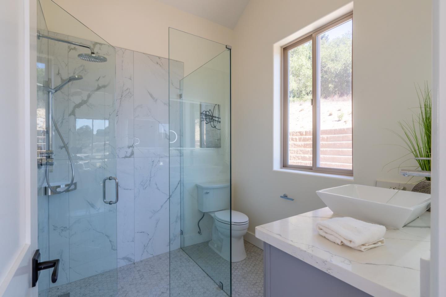 9020 Hidden Canyon Road Salinas, CA 93907 - Photo 56 of 58 a bathroom with a granite countertop shower sink and toilet