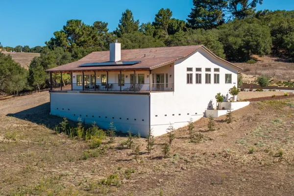 a aerial view of a house with a yard and balcony