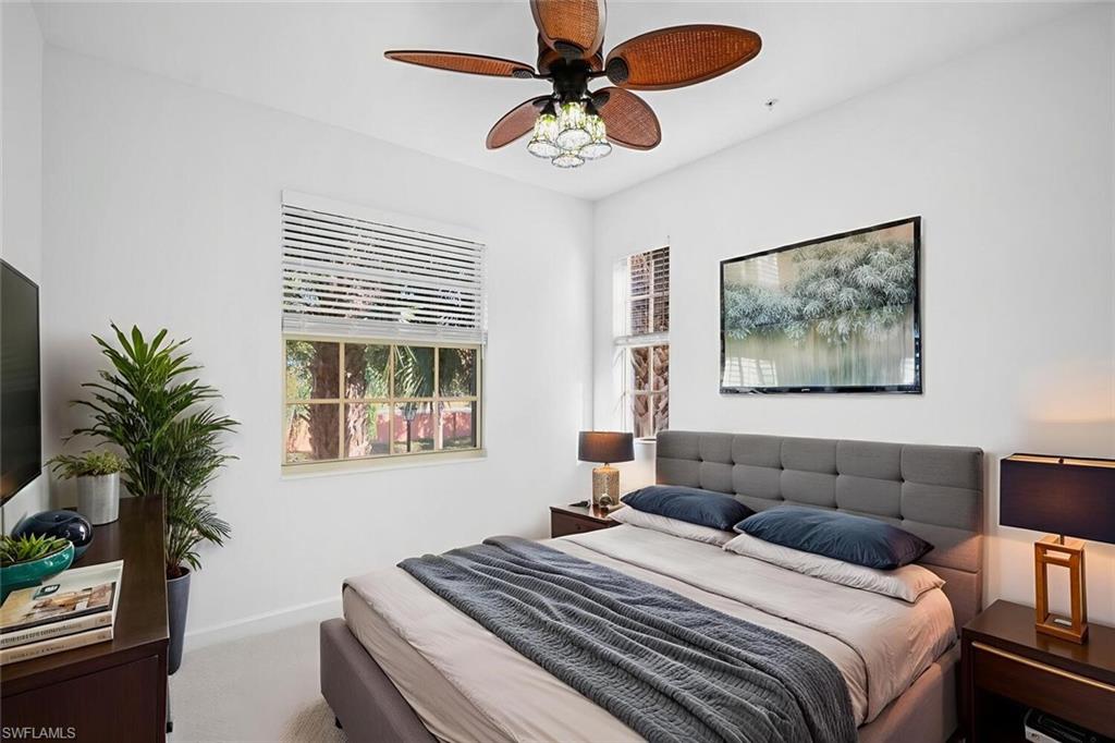 8581 Via Garibaldi Circle, Unit 201 Estero, FL 33928 - Photo 21 of 42 a bedroom with furniture and a large window