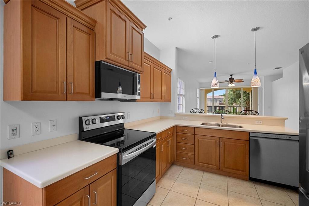 8581 Via Garibaldi Circle, Unit 201 Estero, FL 33928 - Photo 22 of 42 a kitchen with a sink and cabinets