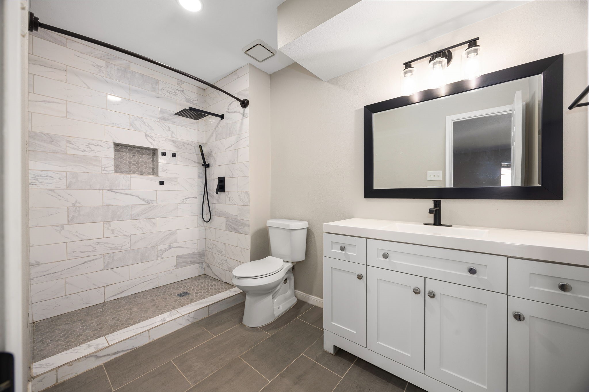 16919 Chapel Pines Drive, Unit 128 Spring, TX 77379 - Photo 14 of 24 This clean, modern en-suite bathroom features a sleek vanity, updated fixtures, and a spacious walk-in shower with timeless tilework, offering a fresh and functional design.