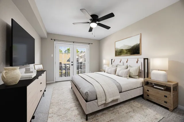 a bedroom with bed and a flat screen tv