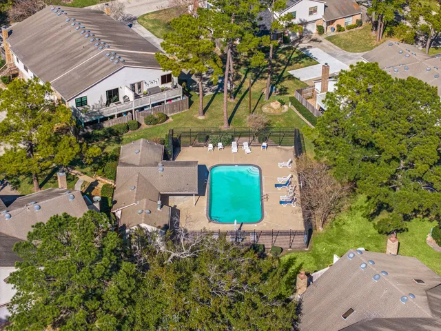 an aerial view of a house with a yard and garden