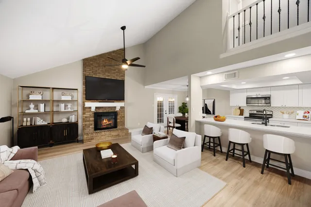 a living room with furniture a fireplace and a flat screen tv