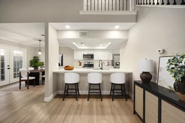 a dining room with furniture and wooden floor