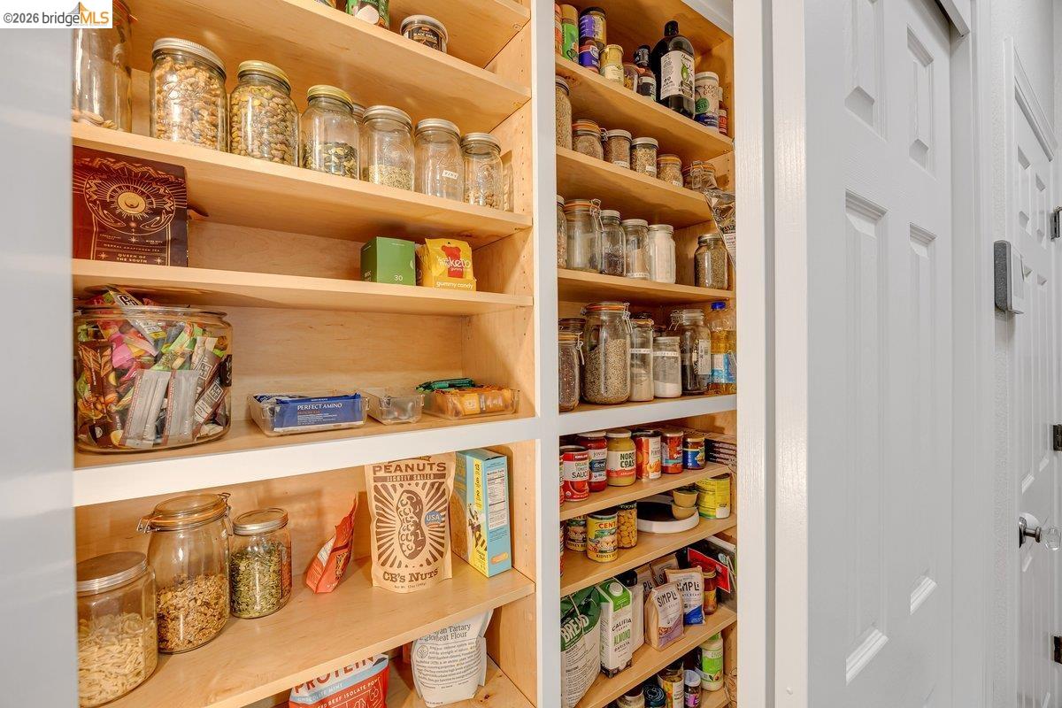 21950 Lyons Bald Mountain Road Sonora, CA 95370 - Photo 21 of 76 Built-in pantry with light wood-finish shelving and white trim, featuring multiple adjustable shelves and panel doors