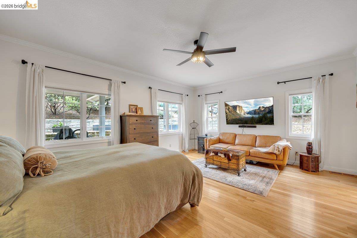 21950 Lyons Bald Mountain Road Sonora, CA 95370 - Photo 25 of 76 a spacious bedroom with a bed and glass window