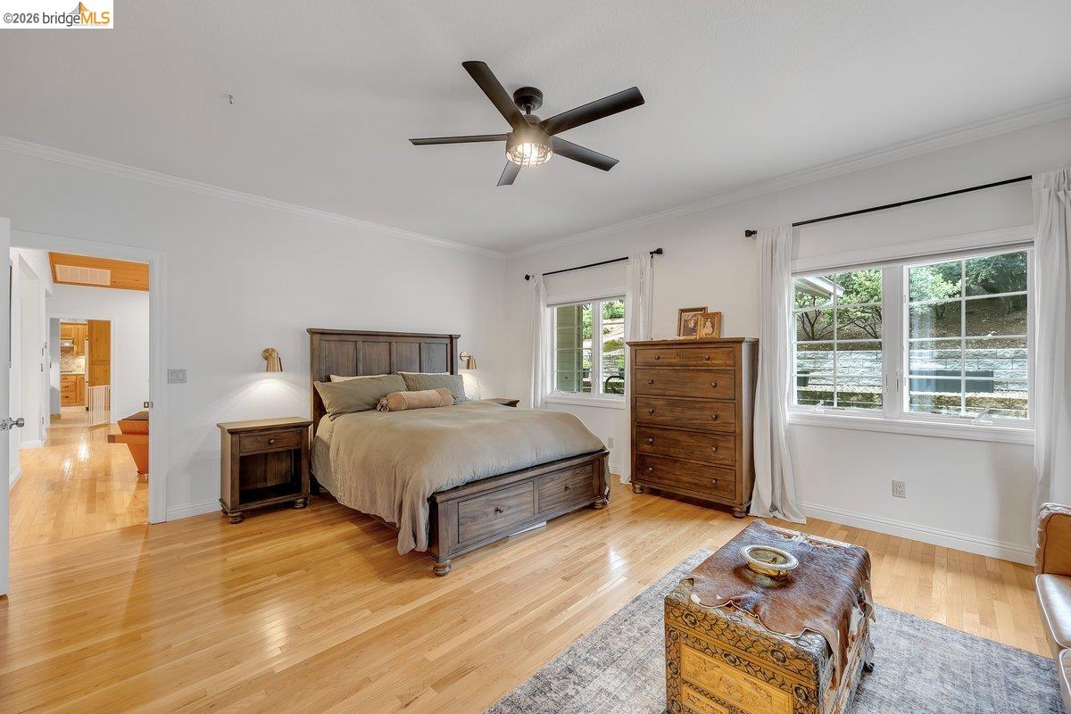 21950 Lyons Bald Mountain Road Sonora, CA 95370 - Photo 26 of 76 a bedroom with a bed and wooden floor