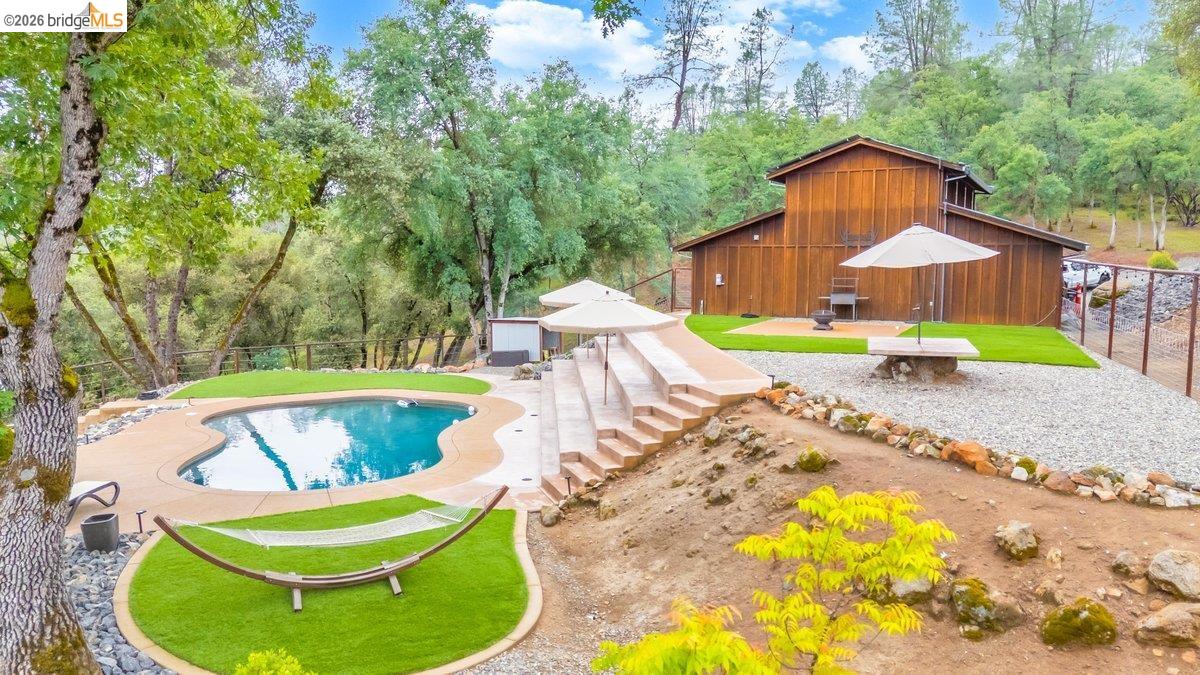 21950 Lyons Bald Mountain Road Sonora, CA 95370 - Photo 59 of 76 a view of a swimming pool with a patio