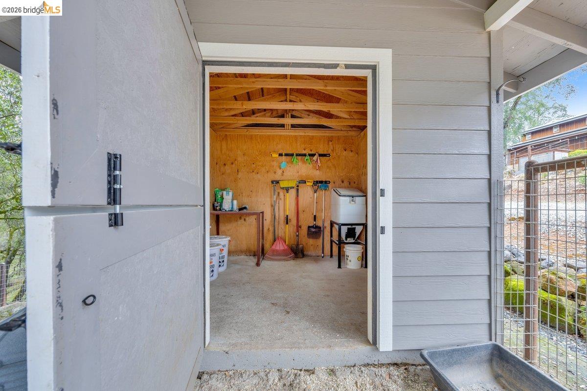 21950 Lyons Bald Mountain Road Sonora, CA 95370 - Photo 66 of 76 Exterior utility shed featuring horizontal siding and exposed interior ceiling joists