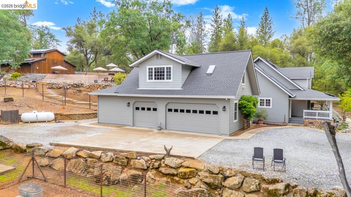 21950 Lyons Bald Mountain Road Sonora, CA 95370 - Photo 69 of 76 a front view of a house with a garden