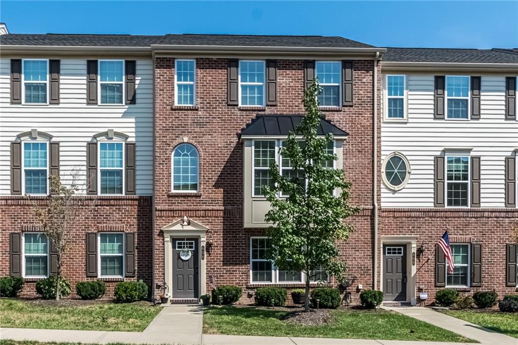  Immaculately maintained move-in ready brick townhome with a bay window is situated in the highly-desired Village at Pine