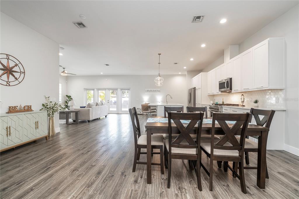 416 Indiana Avenue Crystal Beach, FL 34683 - Photo 12 of 60 a view of a dining room with furniture and wooden floor