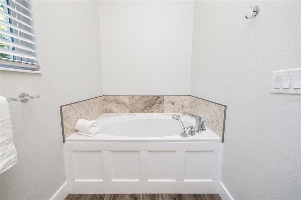 416 Indiana Avenue Crystal Beach, FL 34683 - Photo 18 of 60 a bath tub sitting next to a white sink