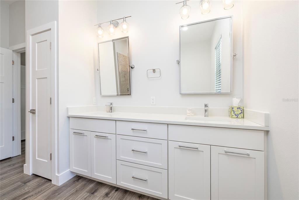 416 Indiana Avenue Crystal Beach, FL 34683 - Photo 20 of 60 a bathroom with double sink and a mirror
