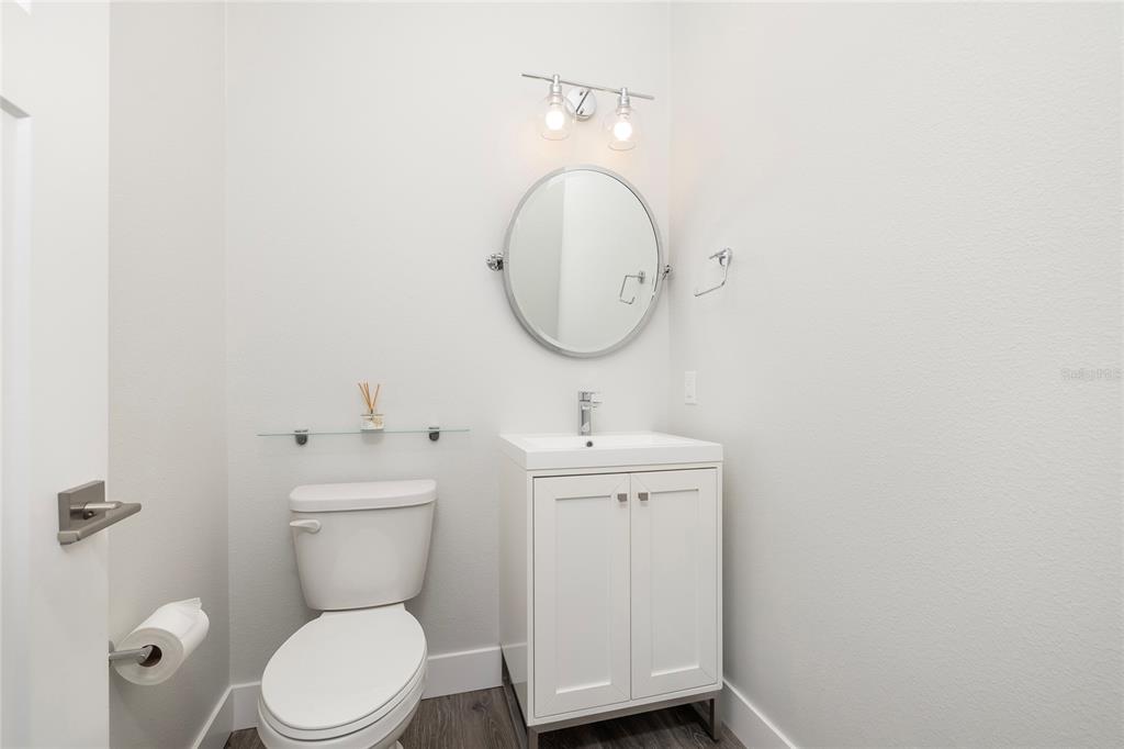 416 Indiana Avenue Crystal Beach, FL 34683 - Photo 27 of 60 a bathroom with a toilet a sink and mirror