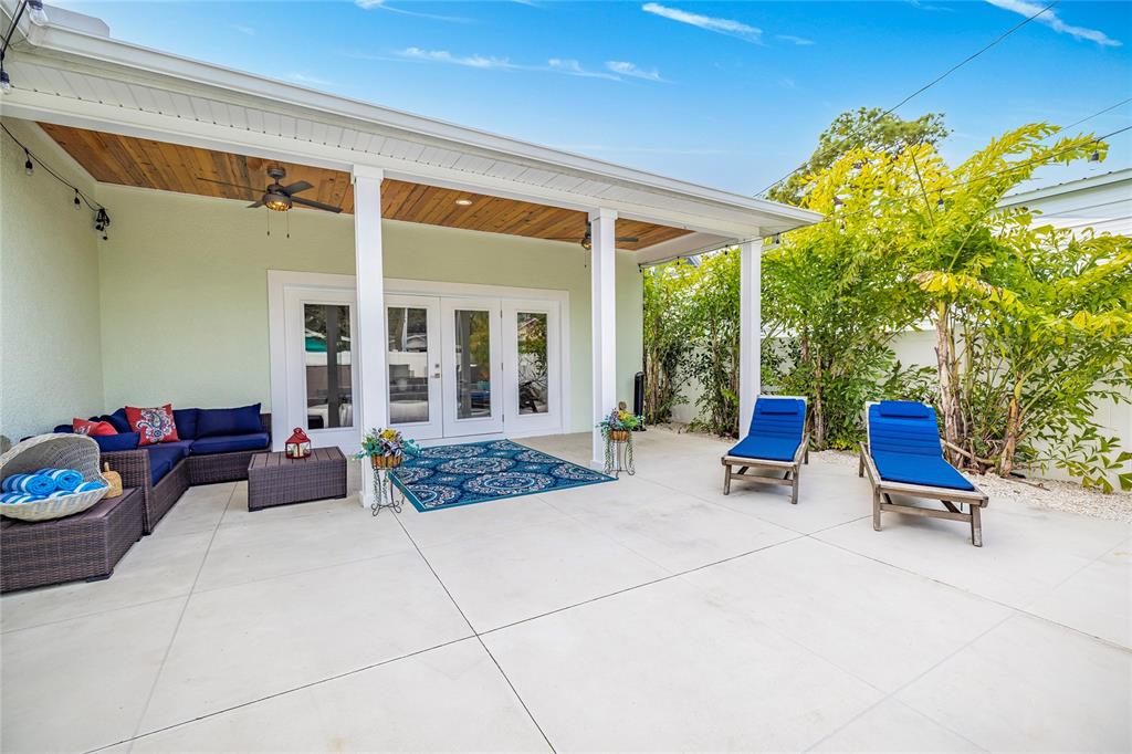 416 Indiana Avenue Crystal Beach, FL 34683 - Photo 39 of 63 a outdoor space with patio the couches and a potted plant on the wall