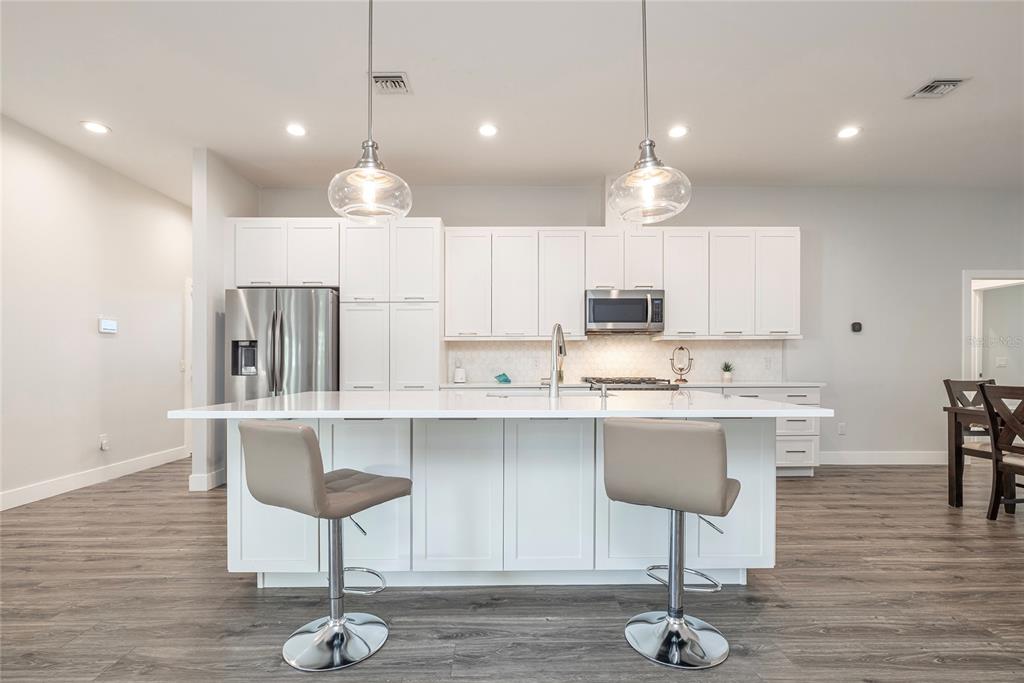 416 Indiana Avenue Crystal Beach, FL 34683 - Photo 6 of 60 a kitchen with stainless steel appliances granite countertop a stove refrigerator sink and cabinets