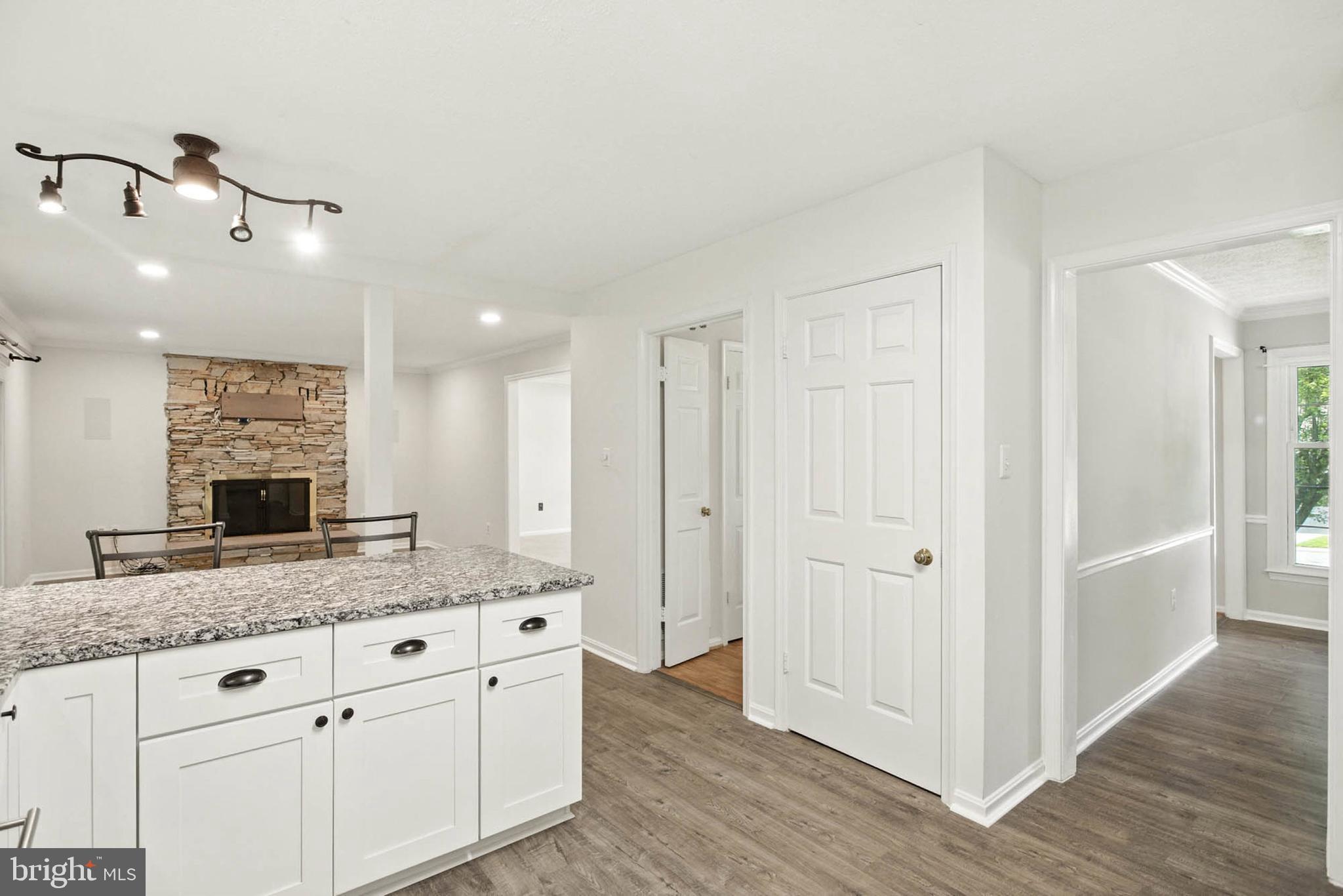 2605 Bainbridge Lane Silver Spring, MD 20906 - Photo 14 of 33 a hall with kitchen island granite countertop white cabinets and a granite counter tops