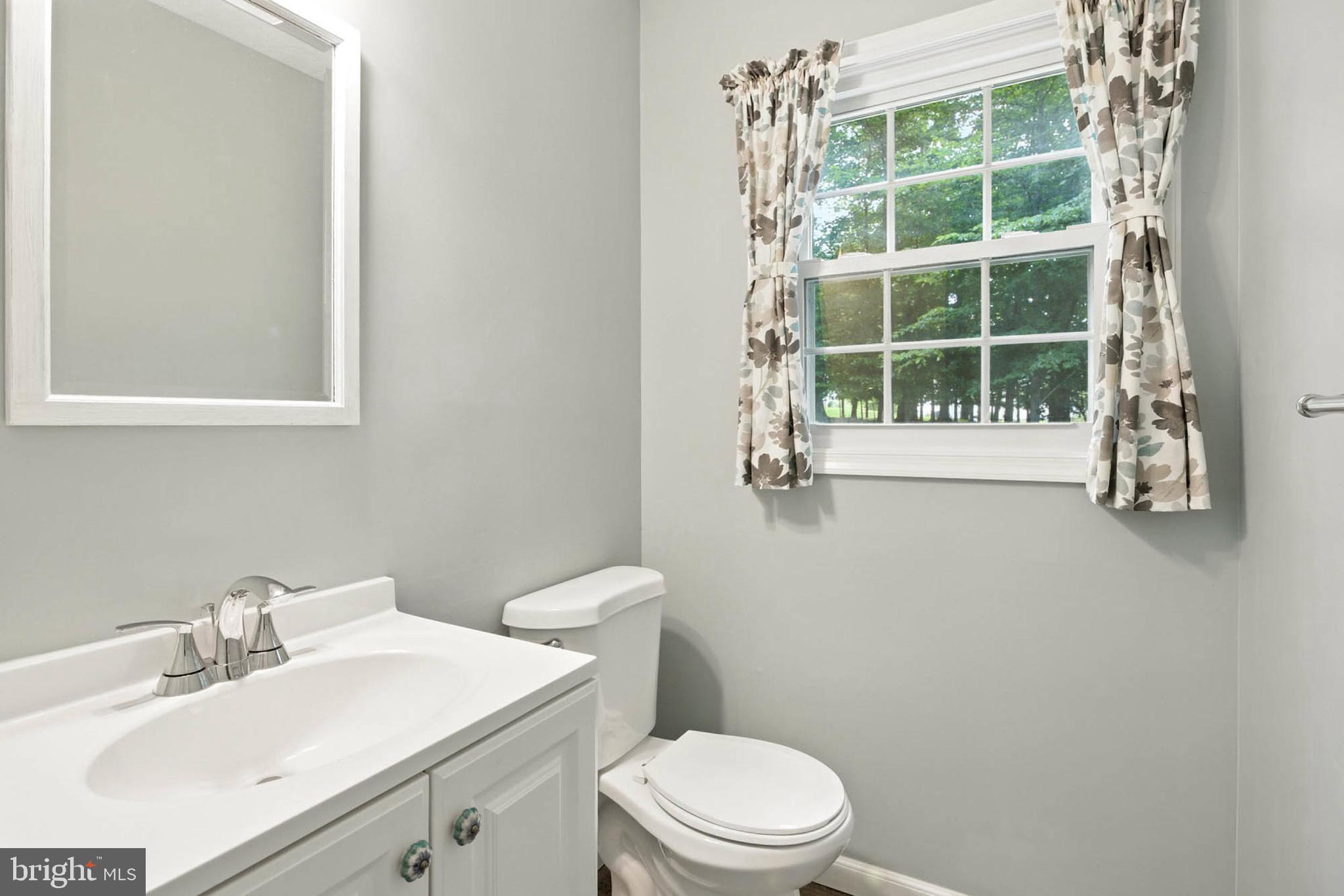 2605 Bainbridge Lane Silver Spring, MD 20906 - Photo 15 of 33 a bathroom with a sink a toilet and a window