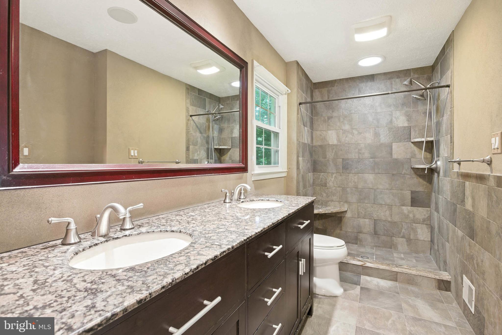 2605 Bainbridge Lane Silver Spring, MD 20906 - Photo 20 of 33 a bathroom with a granite countertop sink mirror and shower