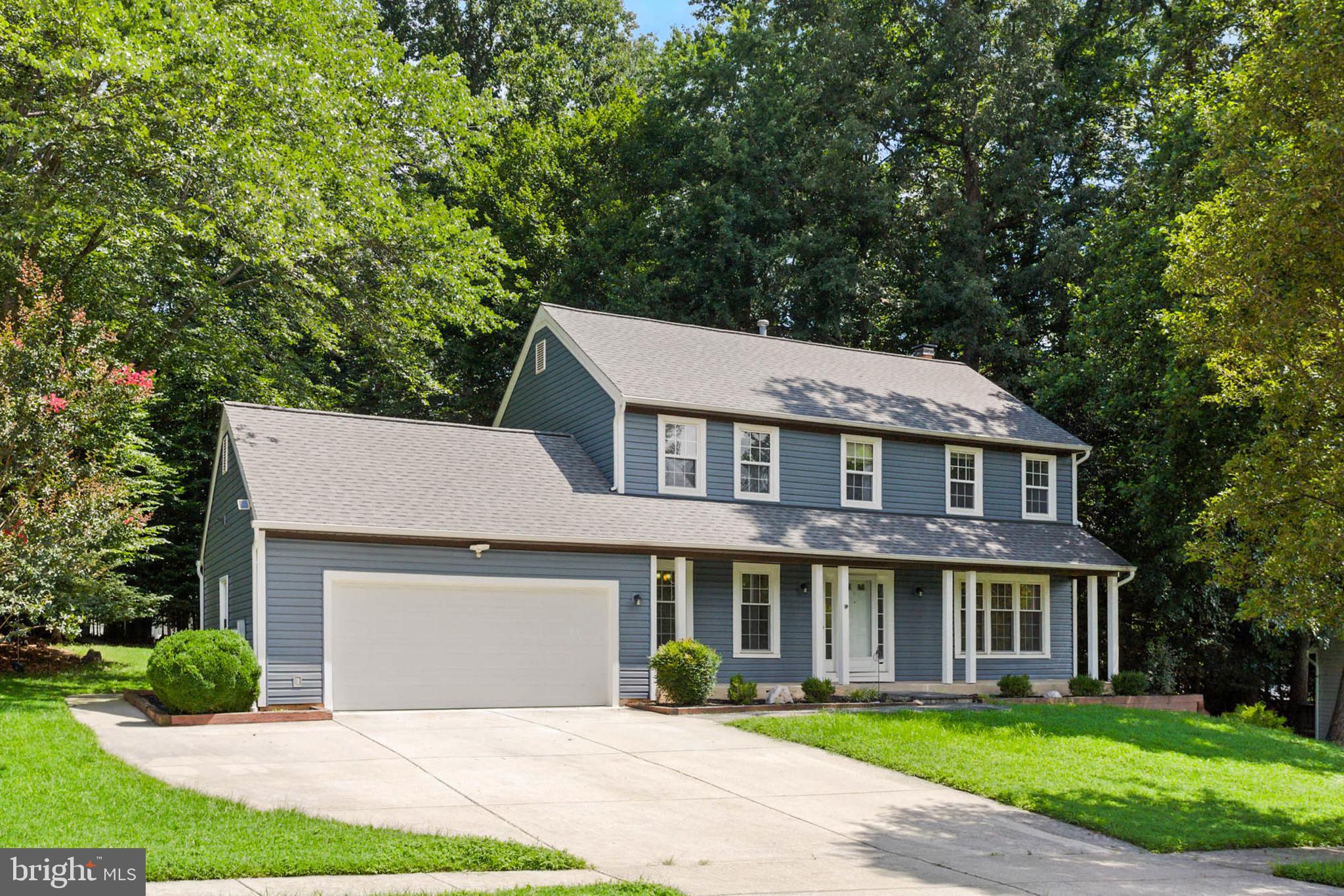2605 Bainbridge Lane Silver Spring, MD 20906 - Photo 2 of 33 a front view of a house with a garden and trees