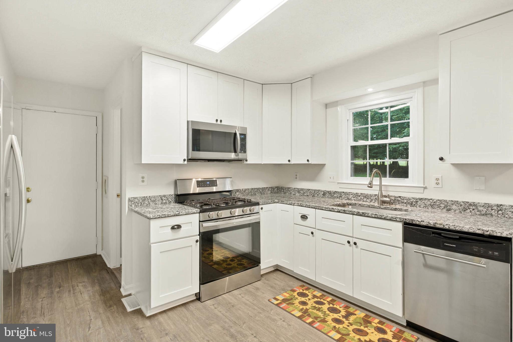 2605 Bainbridge Lane Silver Spring, MD 20906 - Photo 10 of 33 a kitchen with cabinets appliances a sink and a window