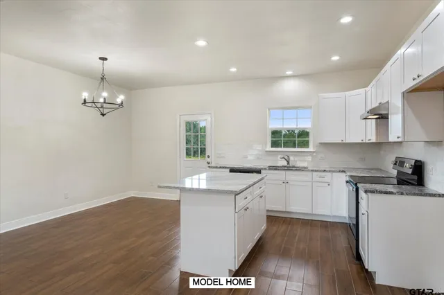 a kitchen with a sink stove and cabinets