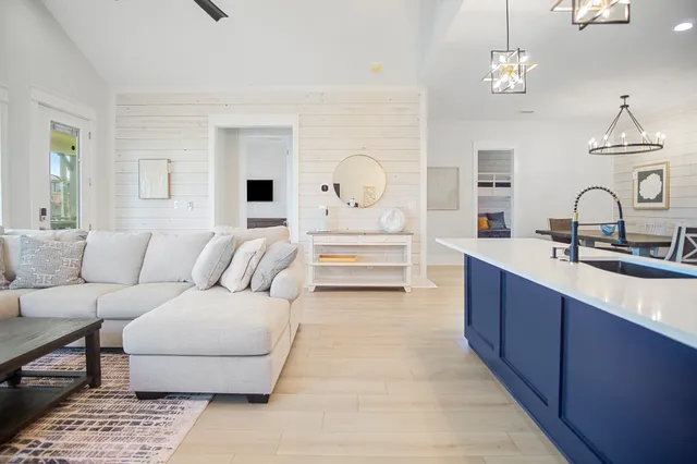 a living room with furniture and a chandelier