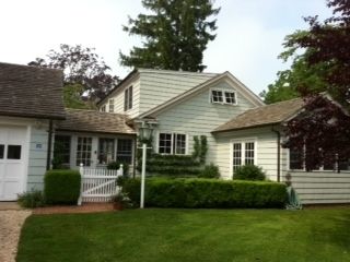 a front view of a house with a garden