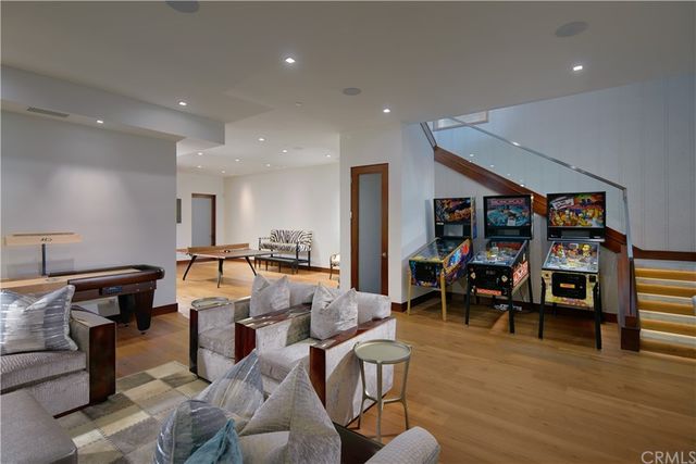 a living room with furniture a wooden floor and next to a window