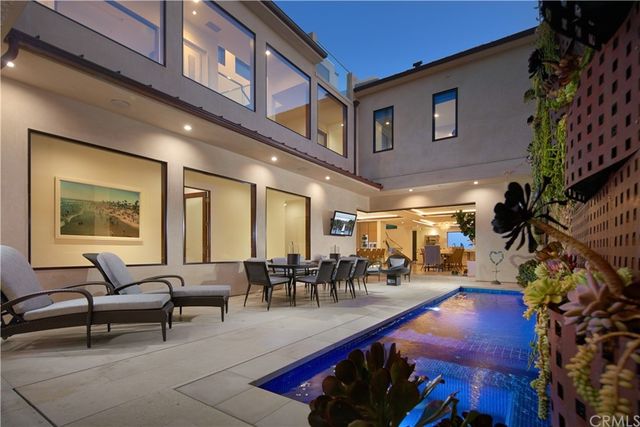 a living room with furniture a dining table and a potted plant