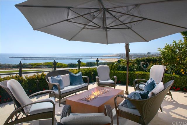 a outdoor sitting area with furniture and umbrella