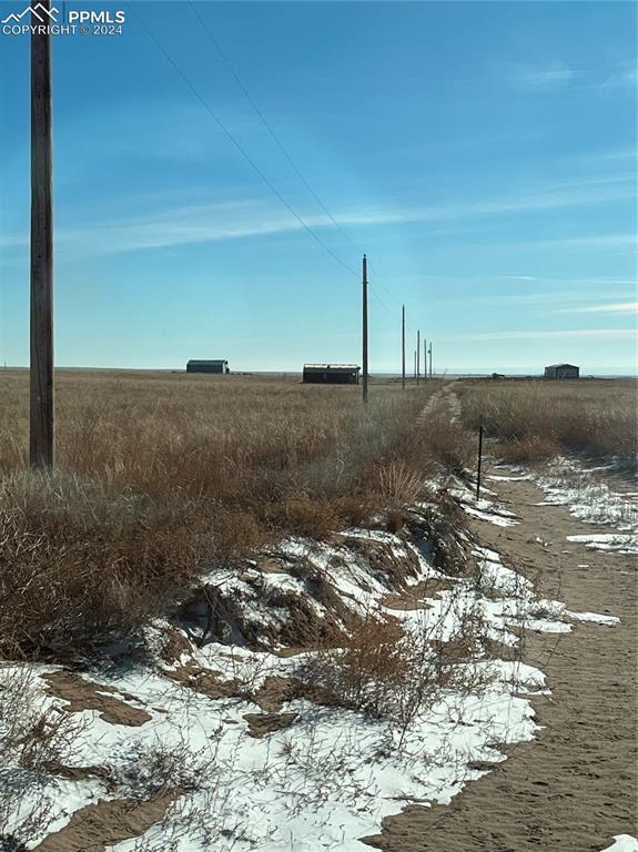 29995 Fred View Road Yoder, CO 80864 - Photo 1 of 12 a view of a dry yard with wooden fence