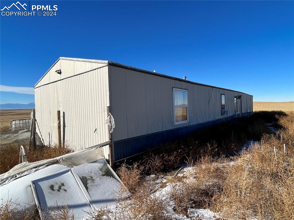 29995 Fred View Road Yoder, CO 80864 - Photo 5 of 12 a black car parked in front of house