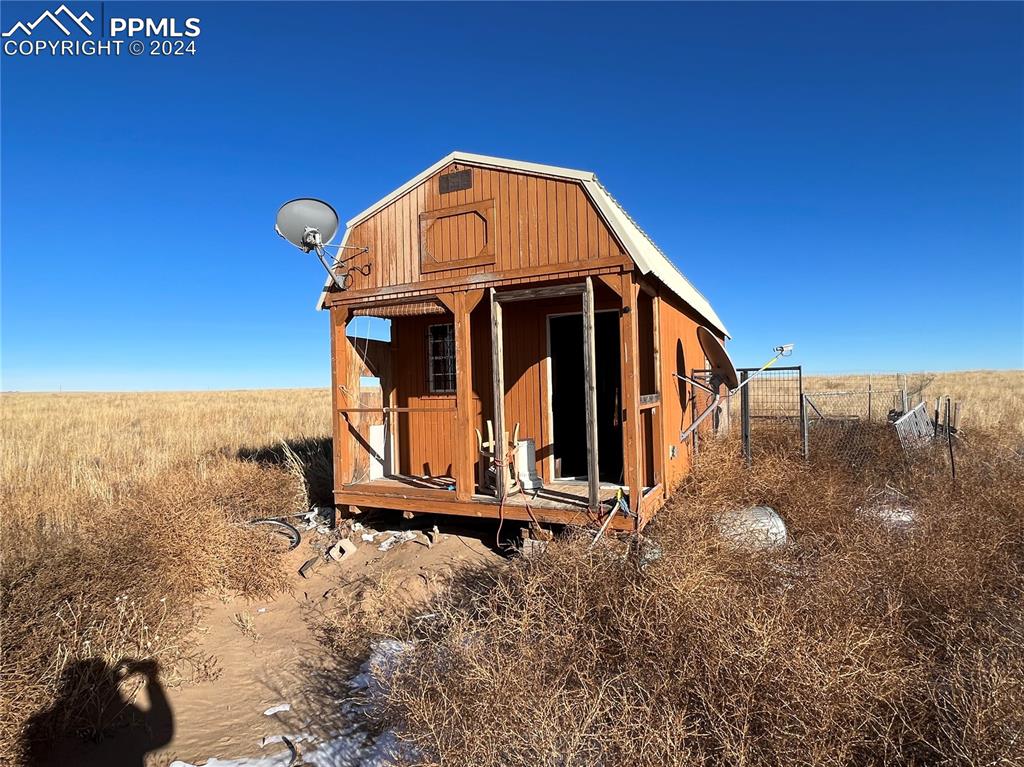 29995 Fred View Road Yoder, CO 80864 - Photo 7 of 12 a view of a tiny house with a yard