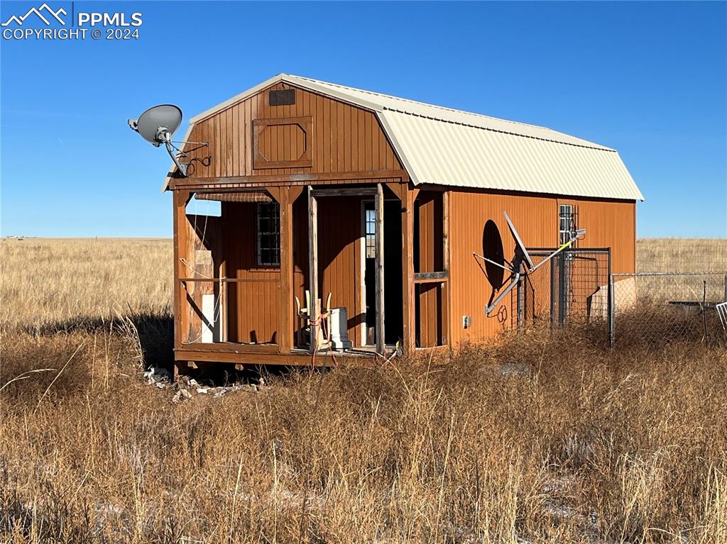 29995 Fred View Road Yoder, CO 80864 - Photo 8 of 12 a front view of a house with a yard
