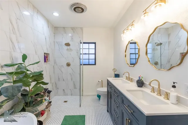 a bathroom with a sink mirror and vanity