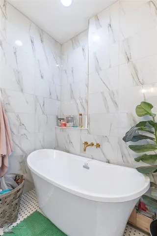 a white bath tub sitting in a bathroom