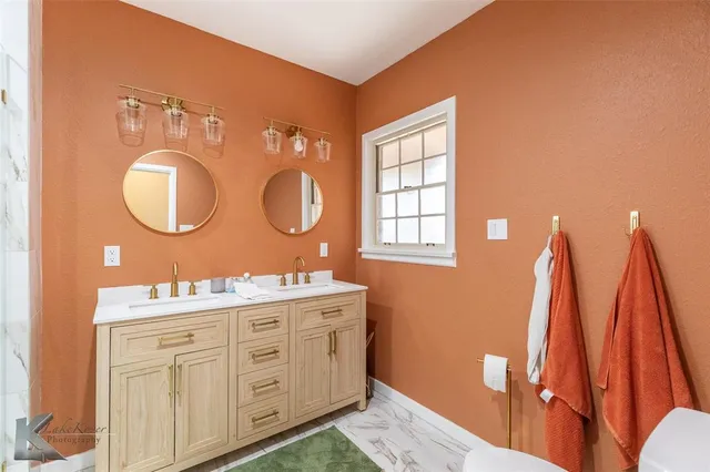 a bathroom with a double vanity sink and a mirror