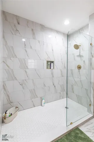 a bathroom with a bathtub and shower