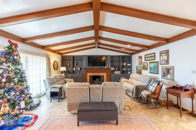 a living room with furniture potted plants and a fireplace
