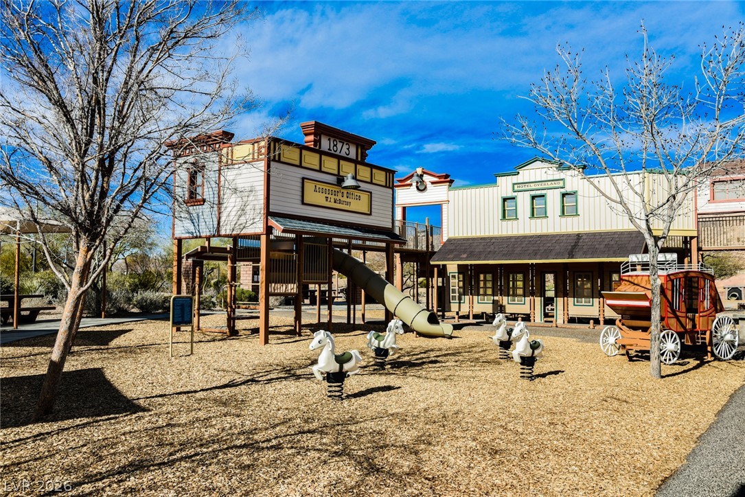 9916 Sable Point Street Las Vegas, NV 89178 - Photo 60 of 73 A delightful playground featuring western-themed structures and interactive spring riders.