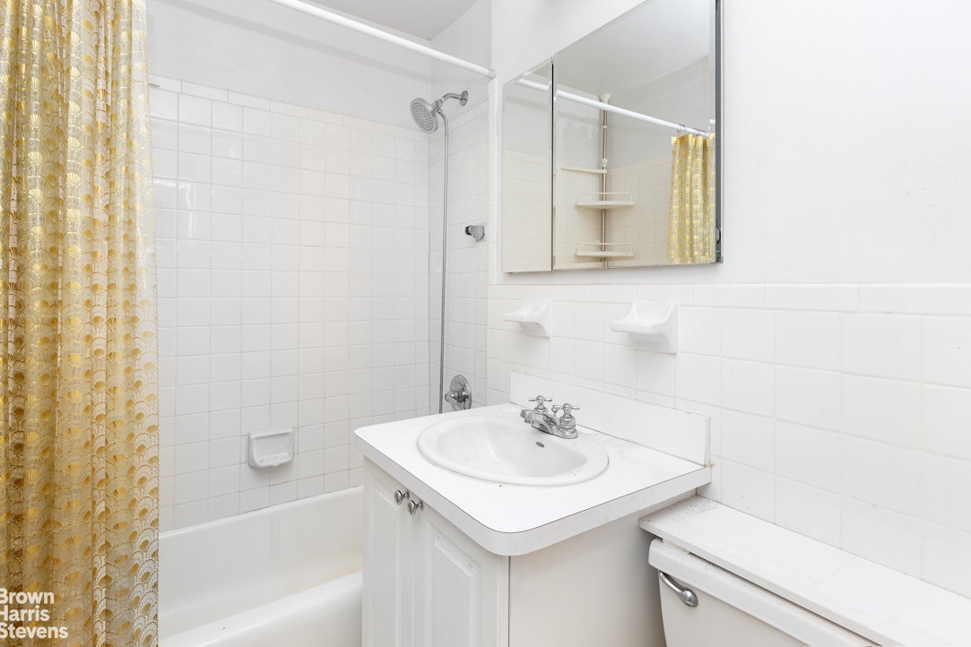 5700 Arlington Avenue, Unit 20S Bronx, NY 10471 - Photo 4 of 15 a bathroom with a sink a toilet and shower