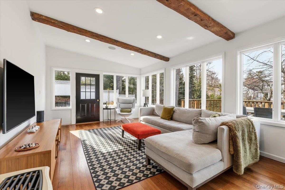 8 Douglas Circle Rye, NY 10580 - Photo 12 of 36 The sunny family room is accented by wooden beams and overlooks the wood deck.