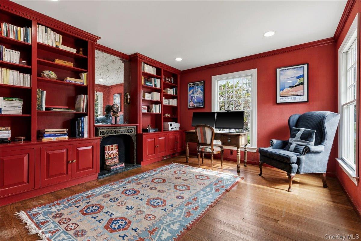 8 Douglas Circle Rye, NY 10580 - Photo 15 of 36 The boldly painted library distills "old world charm" with built-in bookshelves and a faux, mirrored fireplace.