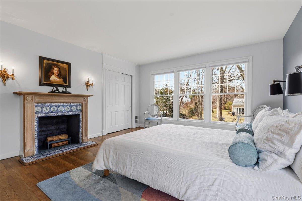 8 Douglas Circle Rye, NY 10580 - Photo 17 of 36 The fireplace and its blue tiles visually lends character to this bedroom.
