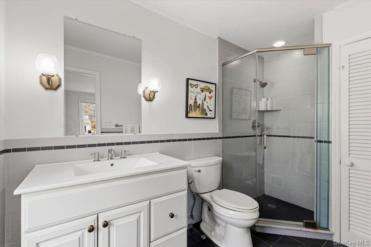 8 Douglas Circle Rye, NY 10580 - Photo 19 of 36 The en-suite bathroom is bright and offers lots of storage.