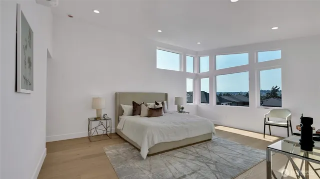 a bedroom with a large bed and a large window